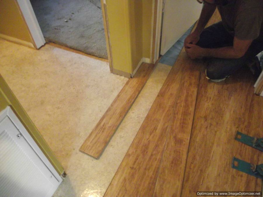 Dream Home, Kensington Manor 12mm laminate flooring Texture close up installing under a door jamb step 2