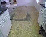 Before photo of Nirvana V-groove laminate flooring installation, removing old vinyl down to bare wood