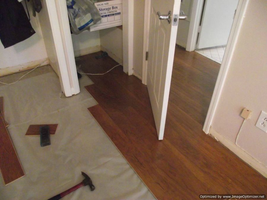 Harmonics laminate flooring installed through bedroom doorway 