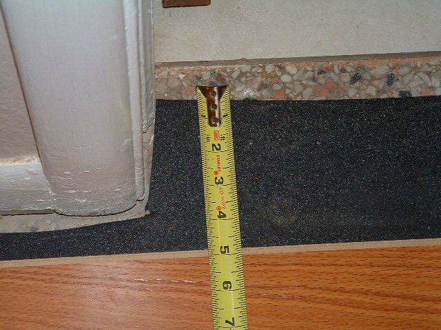 Hallways, installing the last row of laminate flooring in hallway at the ceramic tile in the bathroom doorway.