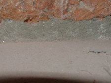 Here in this photo is the fireplace before undercutting it to install laminate or hardwood flooring under it.