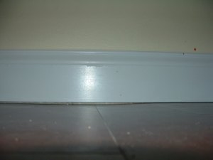 Here is a photo of base board installed on a floor that is not flat with the gap showing.