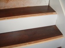 Installing laminate flooring on the stair treads.