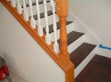 Mohawk laminate flooring from Lowes installed on these stairs with a white painted riser