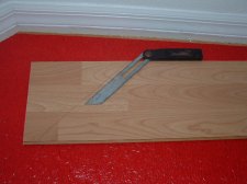 Using the angle finder tool to transfer the angle to the laminate plank.