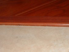 Lumber Liquidators St. James laminate flooring 12mm may be a different height than ceramic tile. This is the finished altered transition.