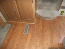 Installing laminate flooring in a travel trailer, installed quarter round by step 