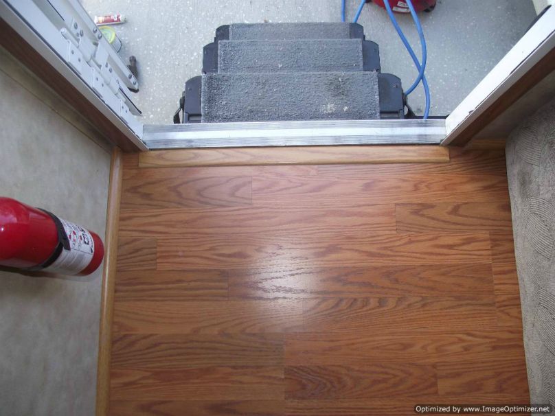 Installing laminate flooring in a travel trailer, installed transition at entry door 