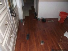 Allen & Roth laminate flooring being installed.in a bedroom into the hallway, 10Mm from Lowes 