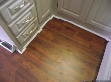 Allen & Roth laminate flooring being installed.in a small kitchen, 10Mm from Lowes 