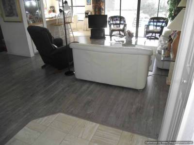 Shaw Gray laminate flooring, installed in living room and around tile entry.