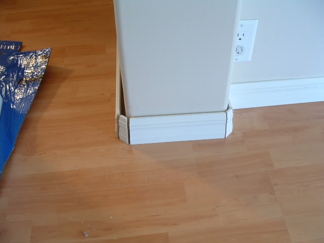 Installing base board on round corners, cutting the base board at 22.5 degree angles to cover the curved corner.