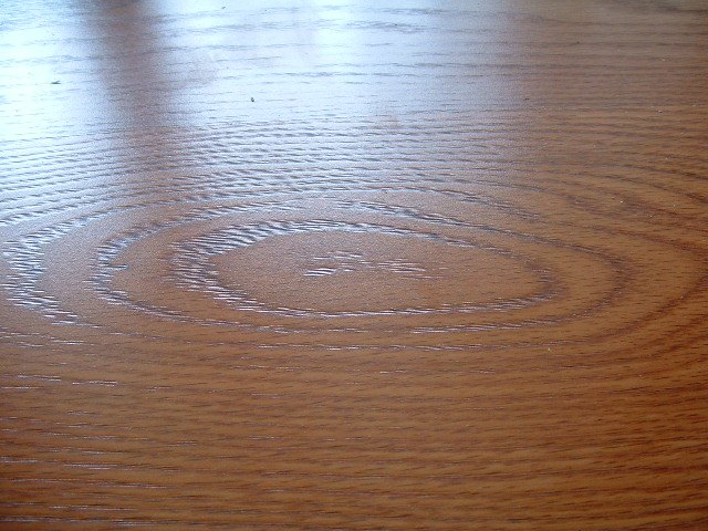 Quick step Eligna laminate flooring single board design showing woodgrain texture.