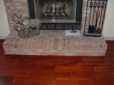 Here in this photo is the finished fireplace after undercutting and installing laminate or hardwood flooring under it.
