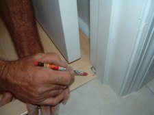 Here I'm notching the laminate trim to fit to the door jamb
