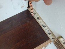 I'm scribing a line on this scrap piece of laminate to get the angle I need in order to cut the laminate stair tread right