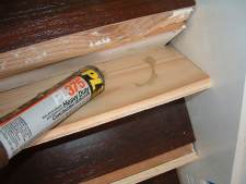 Installing risers for laminate flooring on stairs,applying glue to back of stair riser.