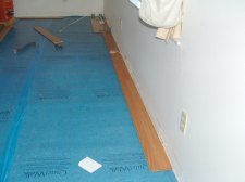 Here I am installing the first row of laminate flooring