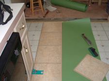 Installing the first row of Quick Step laminate tile flooring