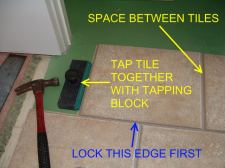 Quick Step tile being tapped together with a tapping block