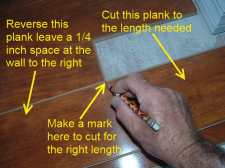 Cutting laminate around corners is easier when I install this temporary plank.