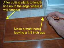Cutting laminate around corners is easier when I install this temporary plank.