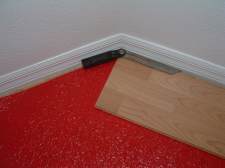 Using the angle finder tool to cut angles when installing laminate flooring.