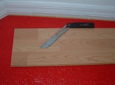 Using the angle finder tool to transfer the angle to the laminate plank.