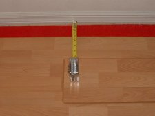 Installing the last row of laminate flooring, now I measure the other end.