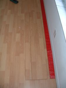Installing the last row of laminate flooring photo
