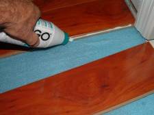 This photo is True floor laminate flooring from Ifloor.com, Color: Tiramisu Surprise, applying glue after shaving off locking system.