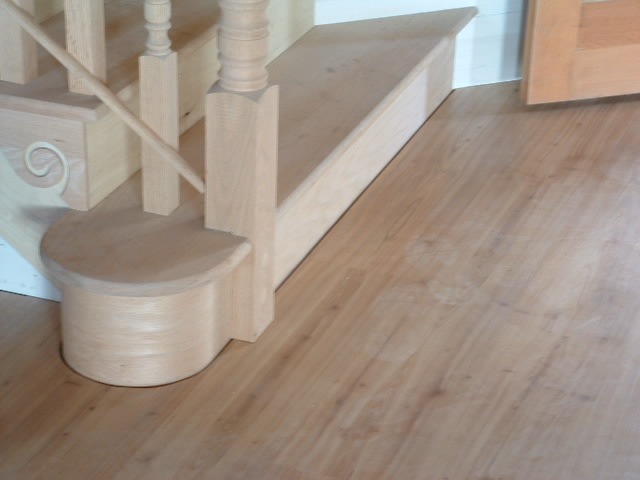 Installing laminate or hardwood around a curved staircase.