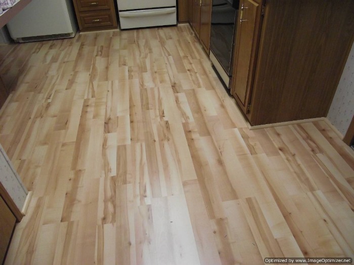 Quick Step Home Sound Blonde Maple laminate flooring installed in the kitchen and hall way.