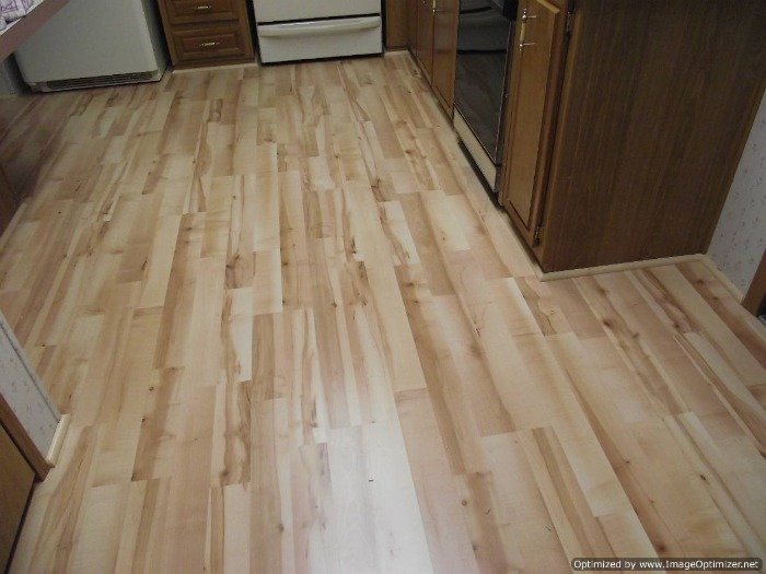 Quick Step Home Sound Blonde Maple laminate flooring installed in the kitchen and hall way.