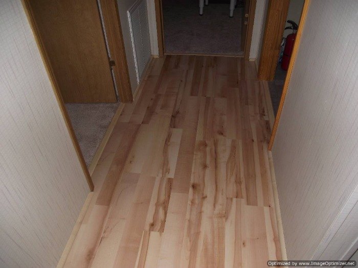 Quick Step Home Sound Blonde Maple laminate flooring installed in the hall way.