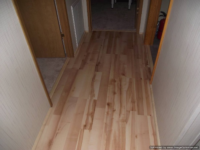 Quick Step Home Sound Blonde Maple laminate flooring installed in the hall way.