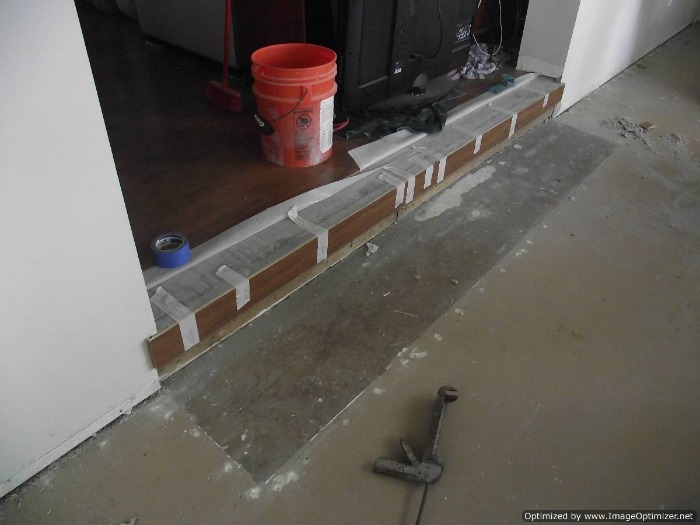 Sunken living room concrete step down to have laminate flooring installed on the concrete sunken living room.