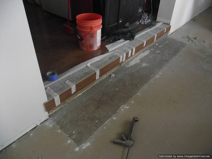 Sunken living room concrete step down to have laminate flooring installed on the concrete sunken living room.