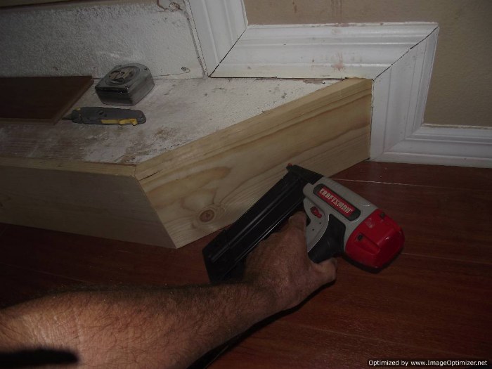 Installing laminate flooring on angled stairs, position the stair nose on the riser so it sits level.