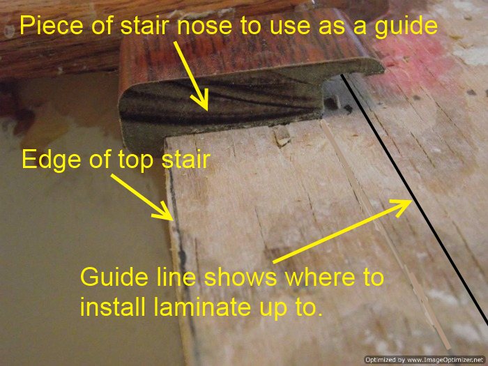 I'm using a piece of stair nose to determine where to stop the laminate flooring on the top stair