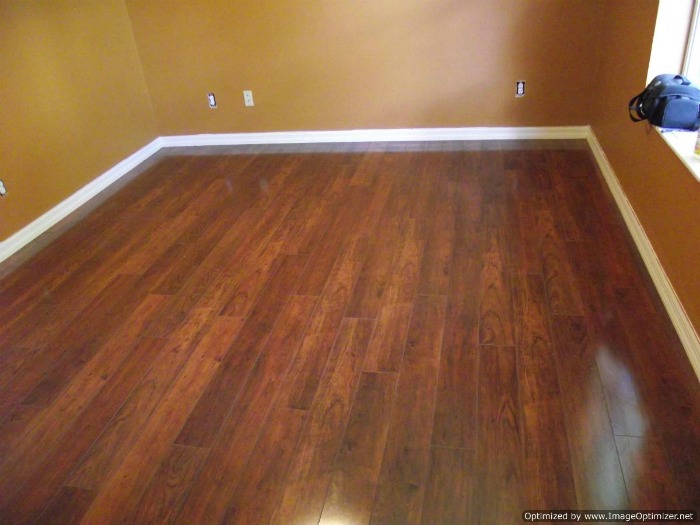 Swiftlock high gloss laminate flooring installed in a bedroom.