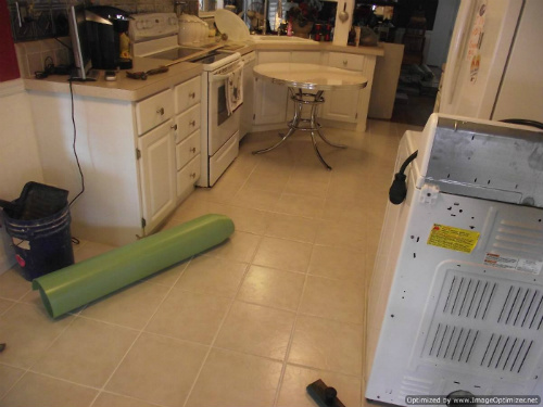 Laminate flooring in kitchen over ceramic tile installation